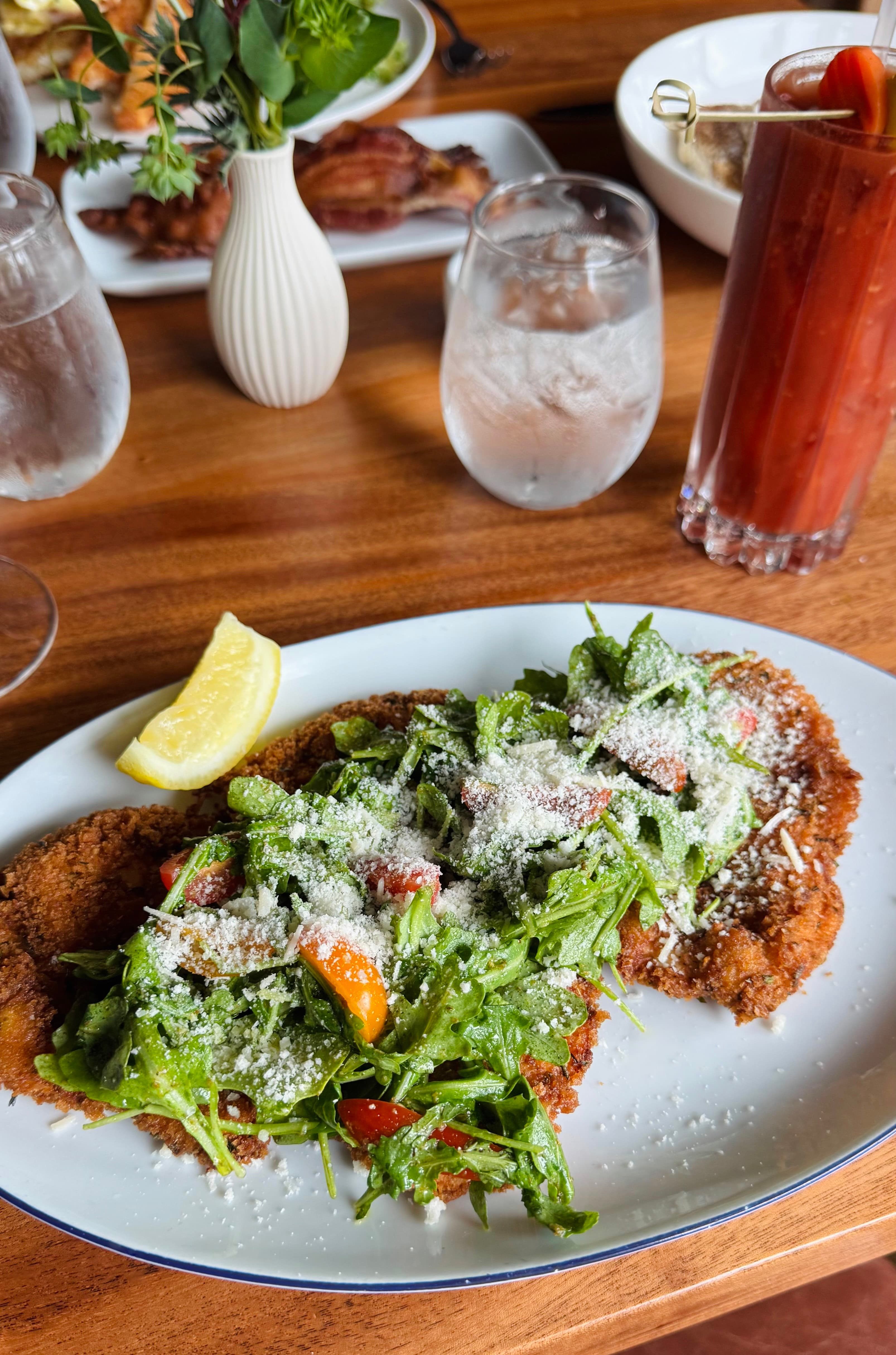 Brined chicken Milanese with arugula and parmigiana